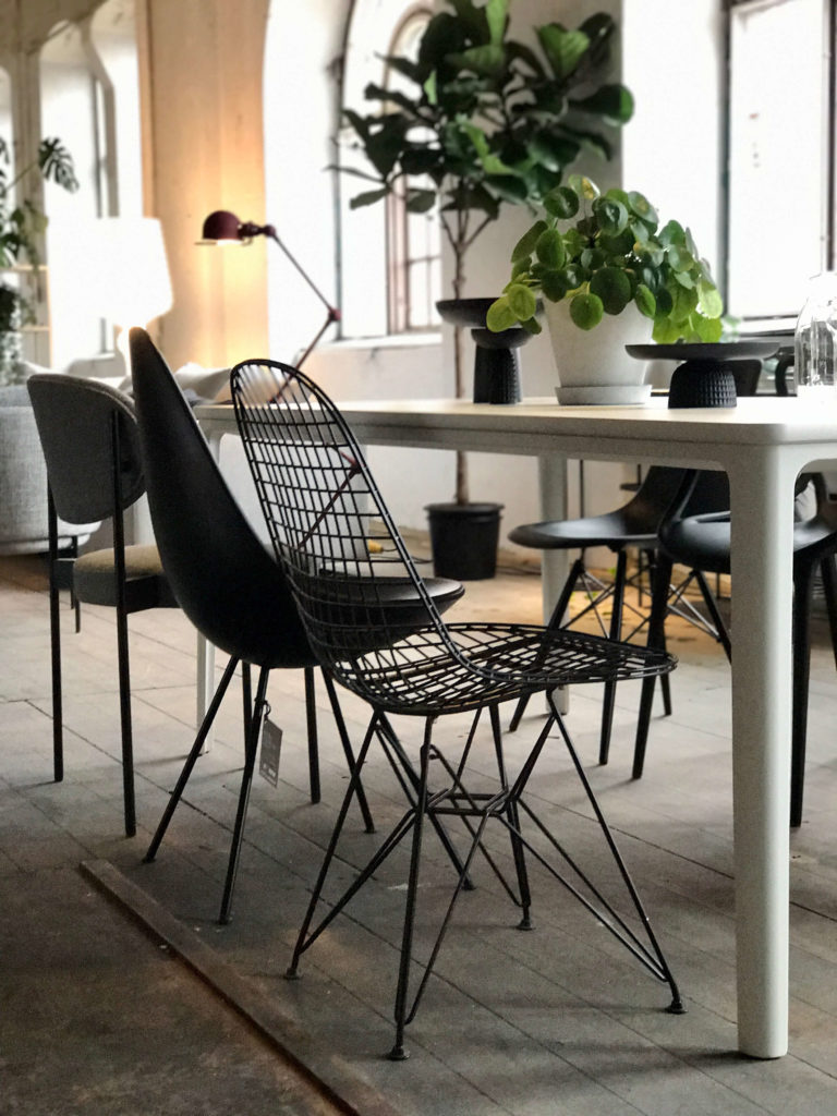 Svarta stolar i olika former runt matbord